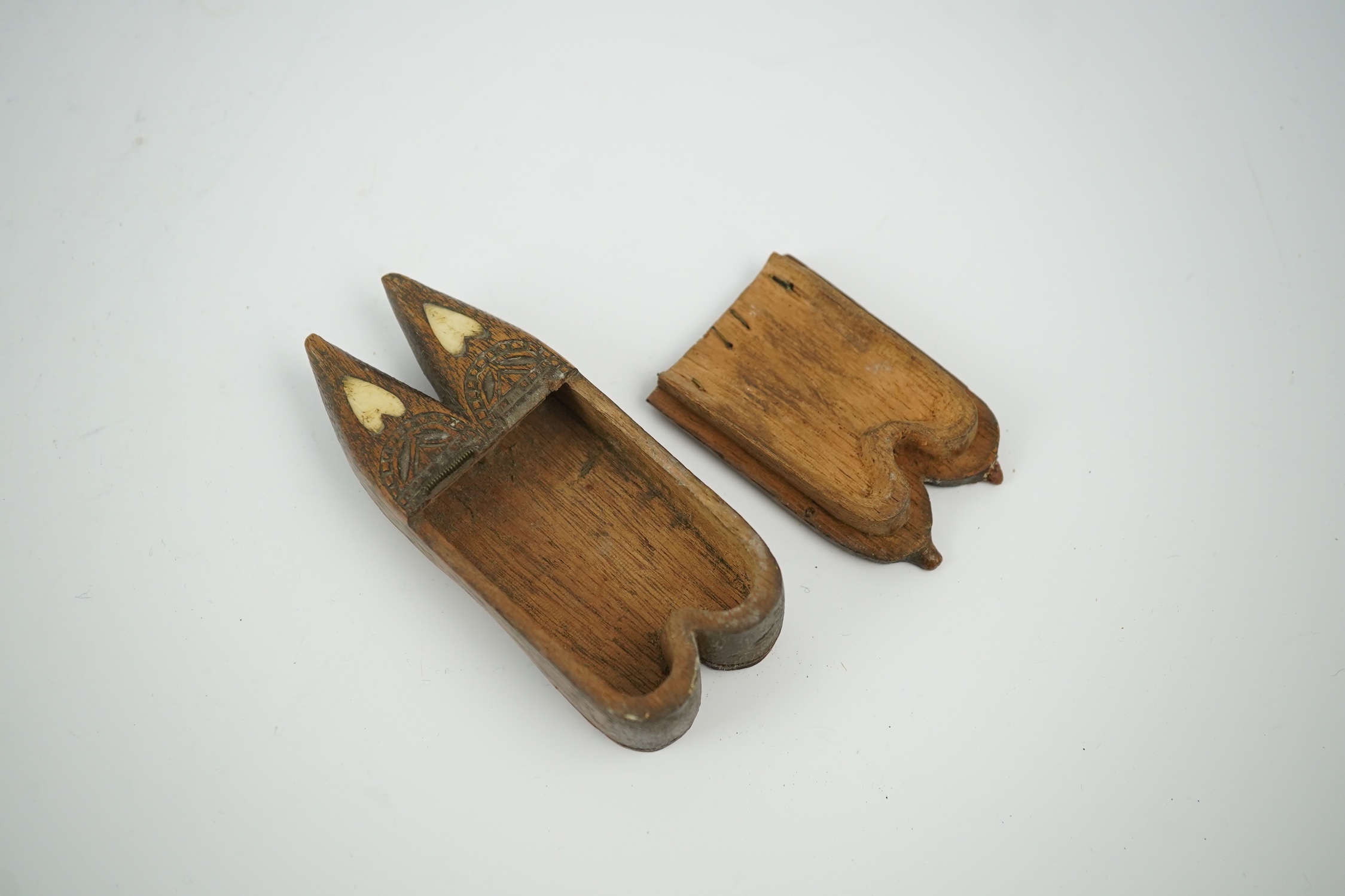 An early 19th century bone inset carved wood 'pair of shoes' snuff box with damaged sprung lid, 9.5cm long. Condition - good